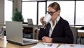 Businesswoman drinking coffee in office, having break, resting after work done Royalty Free Stock Photo