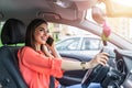 Businesswoman driving car and talking on cell phone concentrating on the road. Driving while holding a mobile phone cell phone use