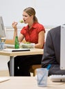 Businesswoman eating salad at desk Royalty Free Stock Photo