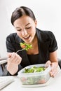 Businesswoman eating salad at desk Royalty Free Stock Photo