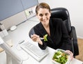 Businesswoman eating salad at desk Royalty Free Stock Photo