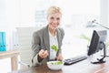 Businesswoman eating salad on her desk Royalty Free Stock Photo