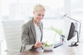 Businesswoman eating salad on her desk Royalty Free Stock Photo