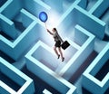 Businesswoman escaping from maze on balloon