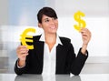 Businesswoman With Euro And Dollar Sign Royalty Free Stock Photo