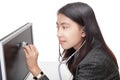 Businesswoman examining PC screen w stethoscope