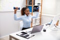 Businesswoman Exercising With Dumbbells