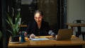 Businesswoman with eye-glasses focusing on her project paperwork report Royalty Free Stock Photo