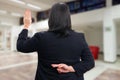 Businesswoman fake oath gesture fingers crossed behind back Royalty Free Stock Photo