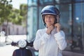 Businesswoman fastening helmet