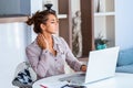 Businesswoman feeling pain in neck after sitting at the table with laptop. Tired female suffering of office syndrome because of Royalty Free Stock Photo