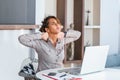 Businesswoman feeling pain in neck after sitting at the table with laptop. Tired female suffering of office syndrome because of Royalty Free Stock Photo