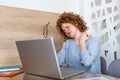 Businesswoman feeling pain in neck after sitting at the table with laptop. Tired female suffering of office syndrome because of Royalty Free Stock Photo