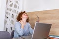 Businesswoman feeling pain in neck after sitting at the table with laptop. Tired female suffering of office syndrome because of Royalty Free Stock Photo