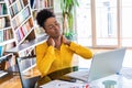 Businesswoman feeling pain in neck after sitting at the table with laptop. Tired female suffering of office syndrome because of Royalty Free Stock Photo