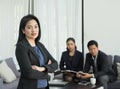 Businesswoman female leader standing and cross arm with team in