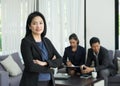 Businesswoman female leader standing and cross arm with team in