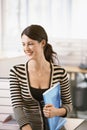 Businesswoman With File Leaning On Cubicle Royalty Free Stock Photo