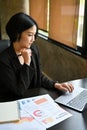 A businesswoman focuses on her work on laptop and working on her marketing project Royalty Free Stock Photo