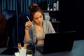 Businesswoman focusing computer with coworker working at back side. Infobahn. Royalty Free Stock Photo