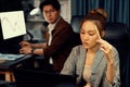 Businesswoman focusing computer with coworker working at back side. Infobahn. Royalty Free Stock Photo