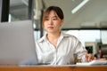 Businesswoman focusing on her project assignment, using laptop computer Royalty Free Stock Photo