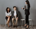 businesswoman with folder choosing colleague