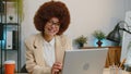 Businesswoman enters office start working on laptop computer at desk and drinking morning coffee