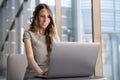 Beautiful global entrepreneur business woman working remotely on a laptop computer, using the internet at the office Royalty Free Stock Photo