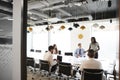 Businesswoman Giving Boardroom Presentation Viewed Through Meeting Room Door Royalty Free Stock Photo