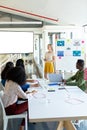 Businesswoman giving presentation on screen during meeting in a modern office Royalty Free Stock Photo