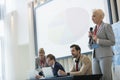 Businesswoman giving presentation in seminar hall Royalty Free Stock Photo