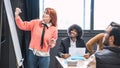 Businesswoman giving presentation to diverse colleagues in conference room Royalty Free Stock Photo