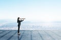 Businesswoman on glass balcony looking into the distance with telescope at city with mock up place. Royalty Free Stock Photo