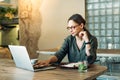 Businesswoman with glasses sitting at the desk and using the laptop. Close up of a woman with glasses working on computer