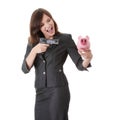 Businesswoman with gun pointing at piggy bank Royalty Free Stock Photo