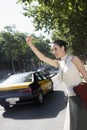 Businesswoman Hailing A Cab Royalty Free Stock Photo