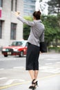 Businesswoman Hailing Taxi In Busy Street Royalty Free Stock Photo