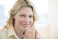 Businesswoman With Hand On Chin Smiling In Office