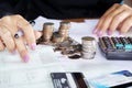 Businesswoman hand counting on saving account with stack of coins