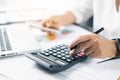 Businesswoman hand doing finances and calculate on desk about cost at home office. Business financing accounting banking concept. Royalty Free Stock Photo