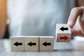 Businesswoman hand flipping Black to Red arrow wooden block on table background. Business, Think Different, Unique, New Way,