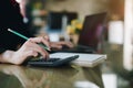 Businesswoman hand pressing on calculator for calculating cost estimating Royalty Free Stock Photo