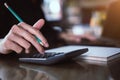 Businesswoman hand pressing on calculator for calculating cost estimating Royalty Free Stock Photo