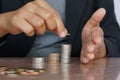 Business woman hand putting money coin stack. Creative ideas for saving money concept Royalty Free Stock Photo