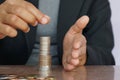 Businesswoman hand putting money coin stack. Creative ideas for saving money concept Royalty Free Stock Photo