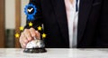 Businesswoman hand ringing silver service bell on hotel reception desk, shows the sign of the top service Quality assurance 5 star