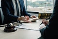 Businesswoman hand sign after Lawyer providing legal consult dispute service at the office with justice scale and gavel hammer Royalty Free Stock Photo