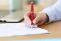 Businesswoman hand signing a contract on a desk Royalty Free Stock Photo