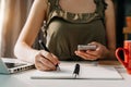 Businessman hand working with new modern computer and writing on the notepad strategy diagram as concept morning light Royalty Free Stock Photo